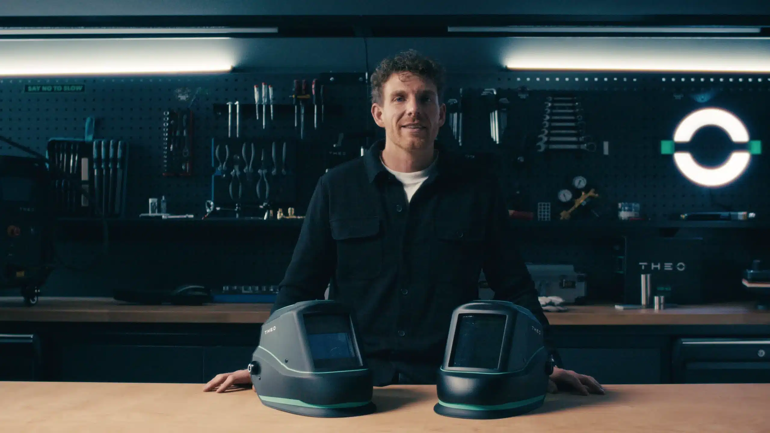 man-two-helmets-smiling-full